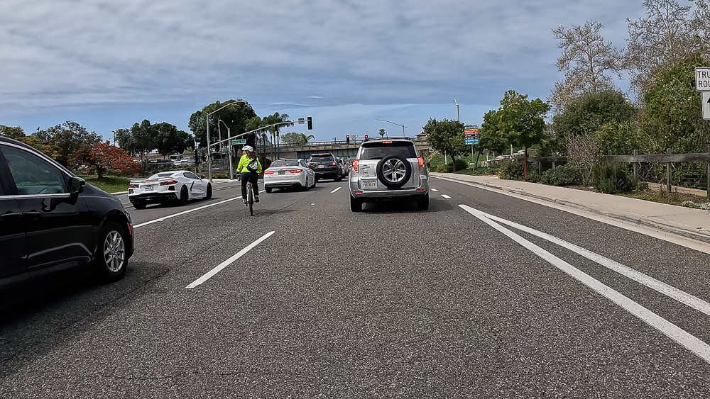 Cyclists crosses multiple lanes of traffic in order to make a left turn in Encinitas, California