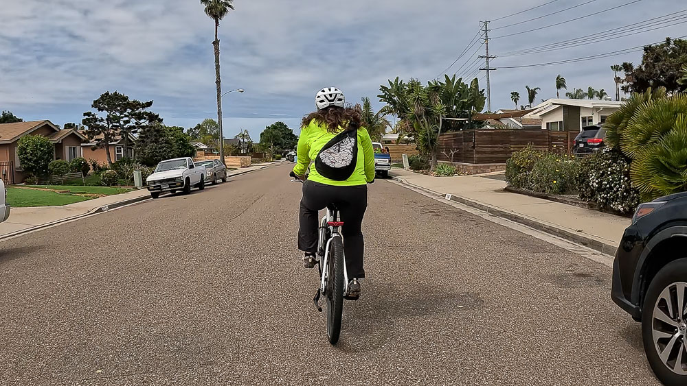 Cyclist rides through a residential neighborhood in Encinitas, California